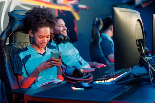 African female cybersport gamer have live stream and playing game on smart phone in gaming club