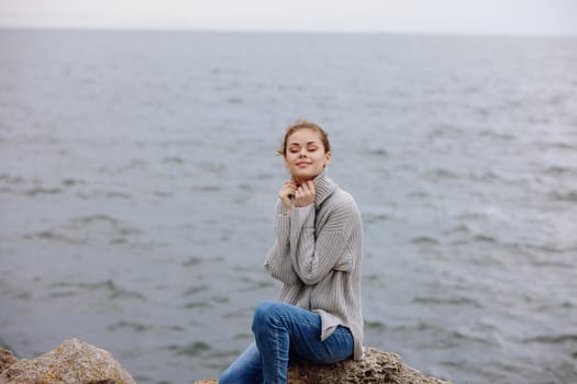woman sweaters cloudy sea admiring nature female relaxing. High quality photo