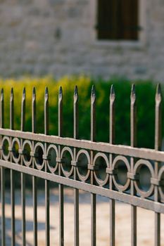 Simple forged metal fence with spikes on top. High quality photo