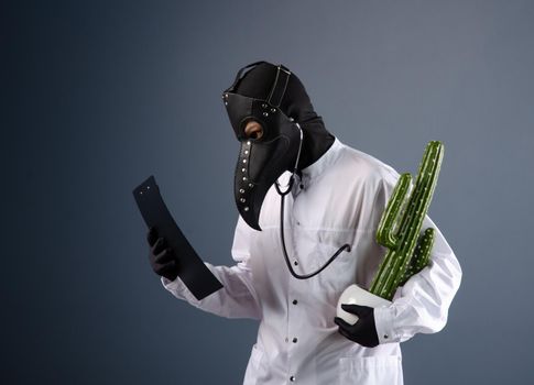 doctor in a dressing gown, wearing a plague doctor mask with a cactus in his hands