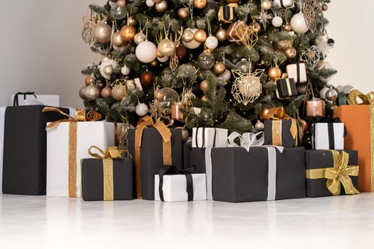 Christmas present box black, orange and white color on white floor with copy space. Holiday gift box