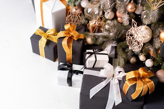 Christmas present box black, orange and white color on white floor with copy space. Holiday gift box
