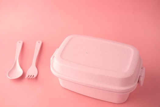 pink color lunch box on color background .