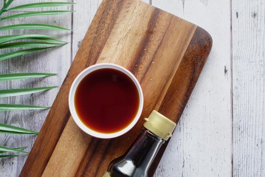 Japanese food cooking set with soy sauce, bamboo sticks on wooden table