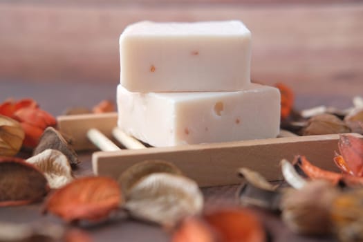 Homemade natural soap bar on black background .