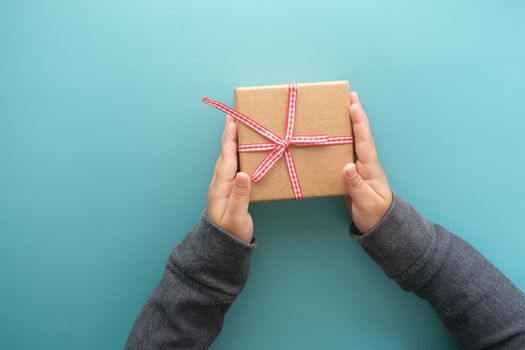 child hand hold homemade gift box.