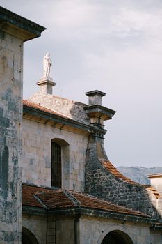 Statue on the roof of the Church of the Nativity of the Virgin in Prcanj. High quality photo