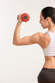 Sports young woman with dumbbells. studio shot. human half