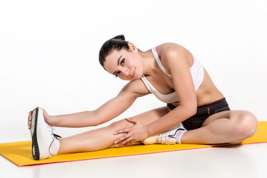 Portrait of young attractive woman doing exercises. Brunette with fit body on yoga mat. Healthy lifestyle and sports concept. Series of exercise poses.