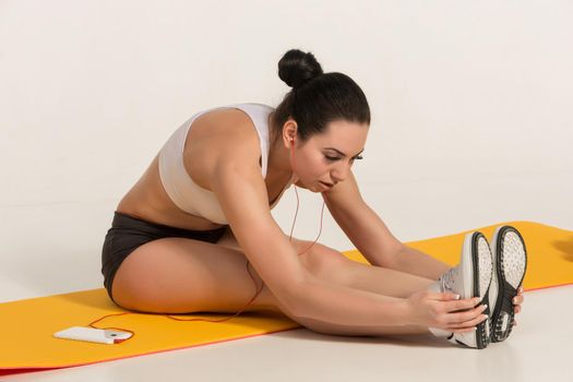 Portrait of young attractive woman doing exercises. Brunette with fit body on yoga mat. Healthy lifestyle and sports concept. Series of exercise poses.