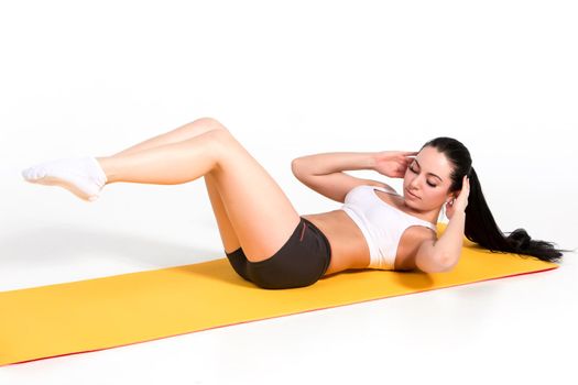 Portrait of young attractive woman doing exercises. Brunette with fit body on yoga mat. Healthy lifestyle and sports concept. Series of exercise poses.