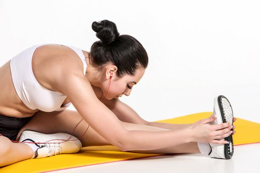 Portrait of young attractive woman doing exercises. Brunette with fit body on yoga mat. Healthy lifestyle and sports concept. Series of exercise poses.