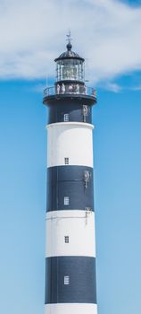 The Chassiron lighthouse with black and white stripes on blue sky, on the island of Oléron in France