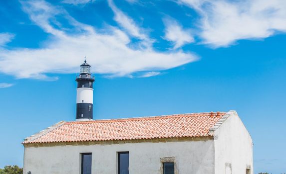 The Chassiron lighthouse with black and white stripes on blue sky, on the island of Oléron in France