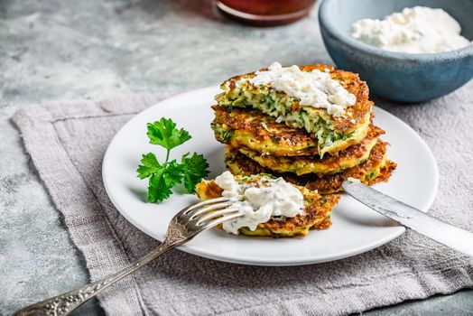 Zucchini parmesan pancakes with dip and parsley