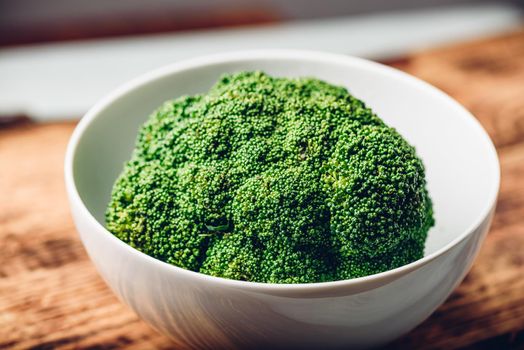 Fresh broccoli in white bowl ready to be prepared for a recipe