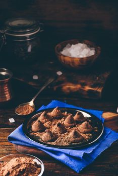 Homemade truffles with dark chocolate on metal tray