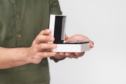 Male hands gives jewelry in a box