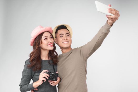 Asian couple take a picture together, smiling and having fun