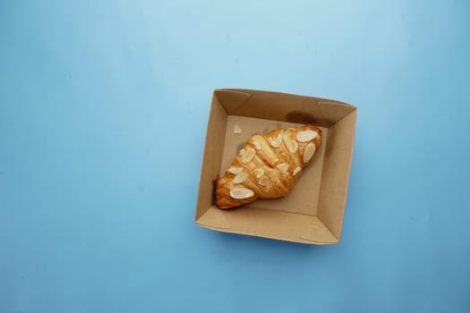 fresh baked croissant in a bow on table .