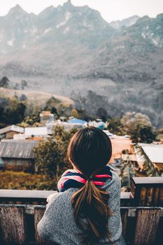 Portrait rear view of young woman looking and enjoying beautiful mountain scenery