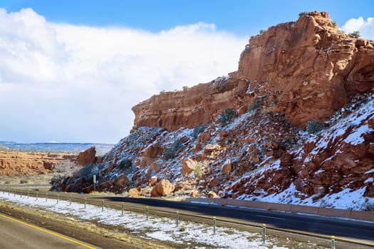 New Mexico road trip, the I-40 highway along mountains covered with snow, amazing landscape picturesque wintertime view