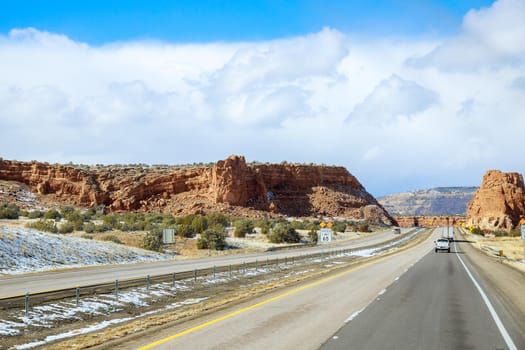 Mountain with snow-covered rocks along I-40 highway in New Mexico US