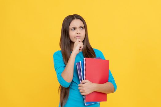 thoughtful child girl hold notepad for homework, school.