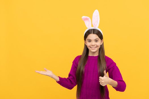 happy easter teen girl in funny bunny ears presenting product, copy space, happy easter.