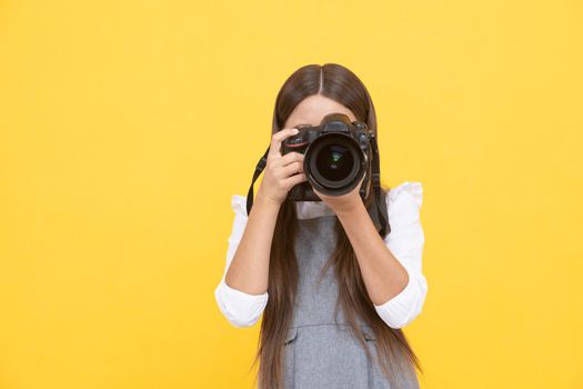 happy teen girl photographer taking picture with digital photo camera, copy space, photographing.