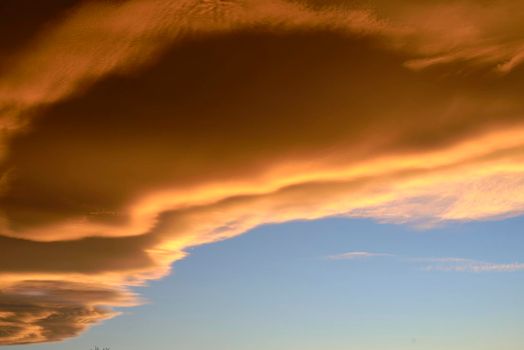 A Sunset. Heaven, orange sky. Sun rays. Wallpaper. Clouds.