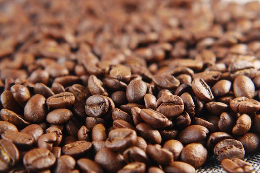 top view of fresh coffee beans on black background with copy space