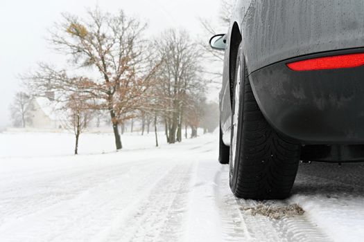 Car in winter in the snow. Winter tires. Winter landscape and  snowy background.