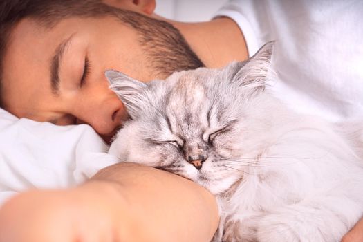 Man sleeping with cat. Lovely cat and owner. Love and trust between owner and cat. . High quality photo