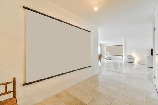 Empty large room of luxury house with wooden flooring and white walls