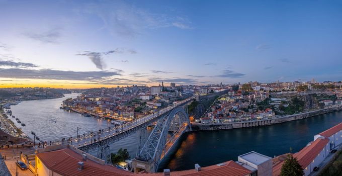 Panorama of Porto with the famous iron bridge and the river Douro after sunset