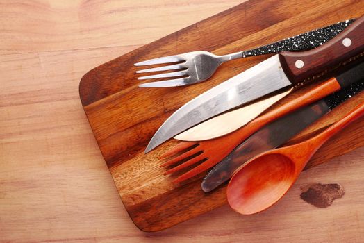 wooden chopping board on black background top down.