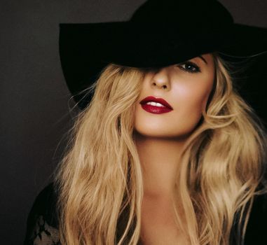 Retro film look and fashion accessory concept. Beautiful blonde woman with long hairstyle wearing black hat as classic glamour style and chic vintage portrait.