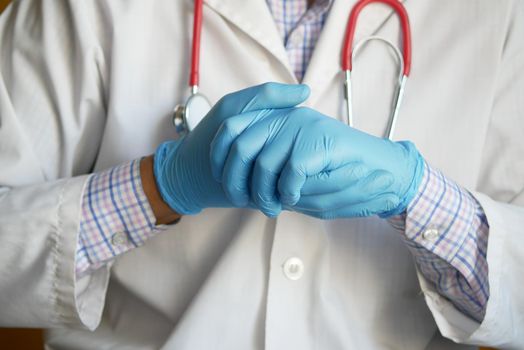 doctor hand with medical gloves showing support sign