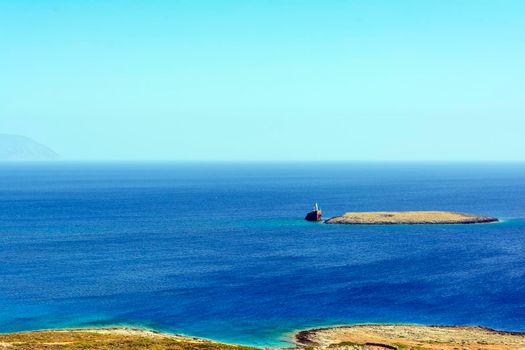 Diakofti port at the Greek island of Kythira. The shipwreck of the Russian boat Norland is in a distance.