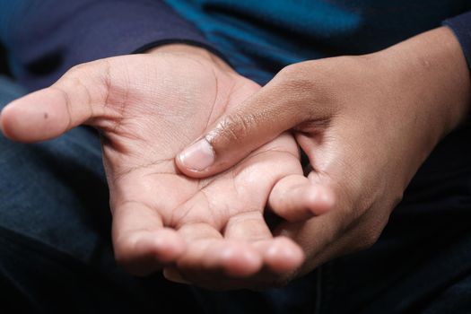 man suffering pain in hand close up .