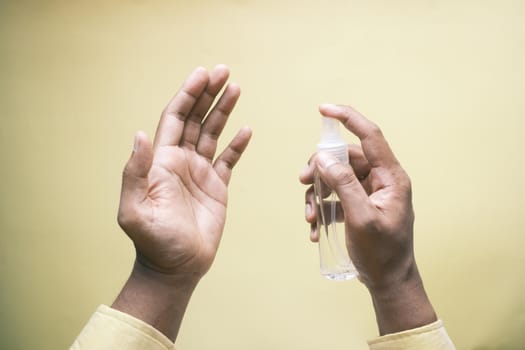 close up of young man hand using hand sanitizer spray