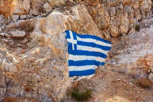 Flag of Greece painted on a rock. Kythira, Greece.
