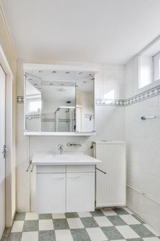 Small bathroom interior with white cabinets, granite countertops and toilet.