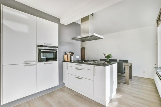 White large luxury modern kitchen with dark chairs