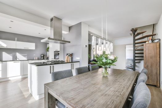 White large luxury modern kitchen with dark chairs