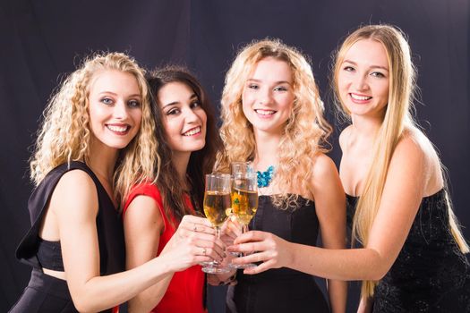 Party, holidays, celebration and new year eve concept - Cheerful young woman clinking glasses of champagne at the party.