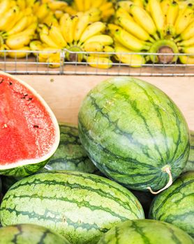 Fruit market with various colorful fresh fruits and vegetables.