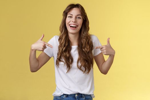 Haha awesome. Positive sincere attractive young woman curly long hair laughing joyfully pointing fingers center copy space white t-shirt chuckling having fun discuss great link show you promo.