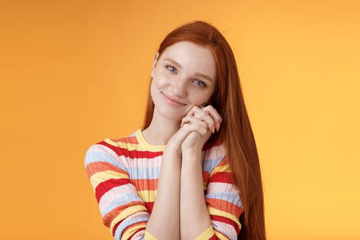 Dreamy sensual romantic young passionate redhead girlfriend melt heart feel sympathy joy receive sweet tender present lean palms smiling grateful gladly accept nice lovely gift, orange background.